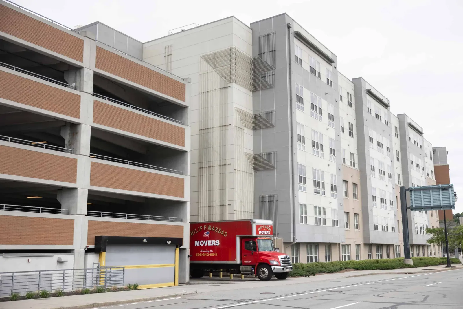 A red truck is parked in front of a building.