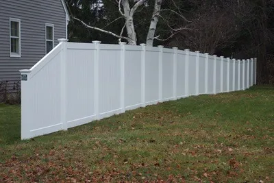 White vinyl privacy fence running down a side yard