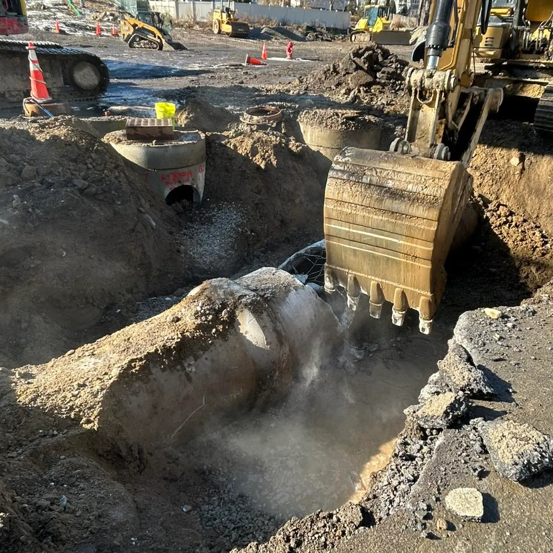 Excavator digging trench for underground utility installation