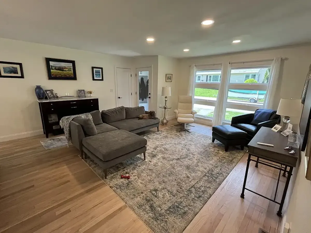 Remodeled living room with refinished hardwood and recessed lighting