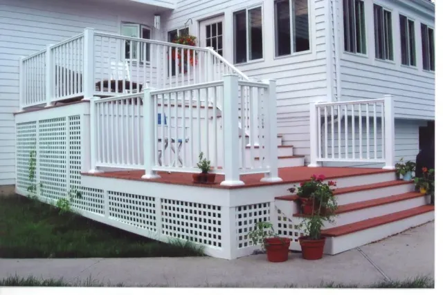 A white house with a white deck and stairs