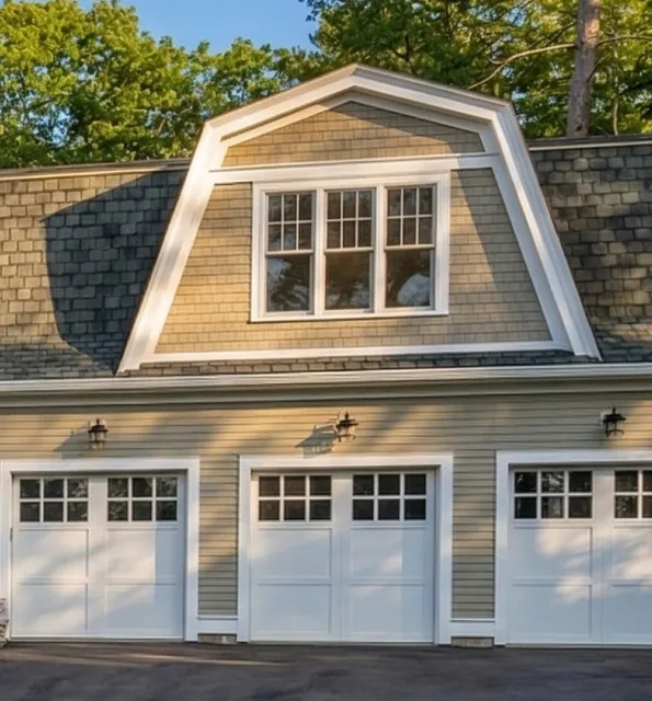 A two-story house at 17 Smith Place features a gambrel roof, shingle siding, and three white garage doors, set against trees and a clear sky.