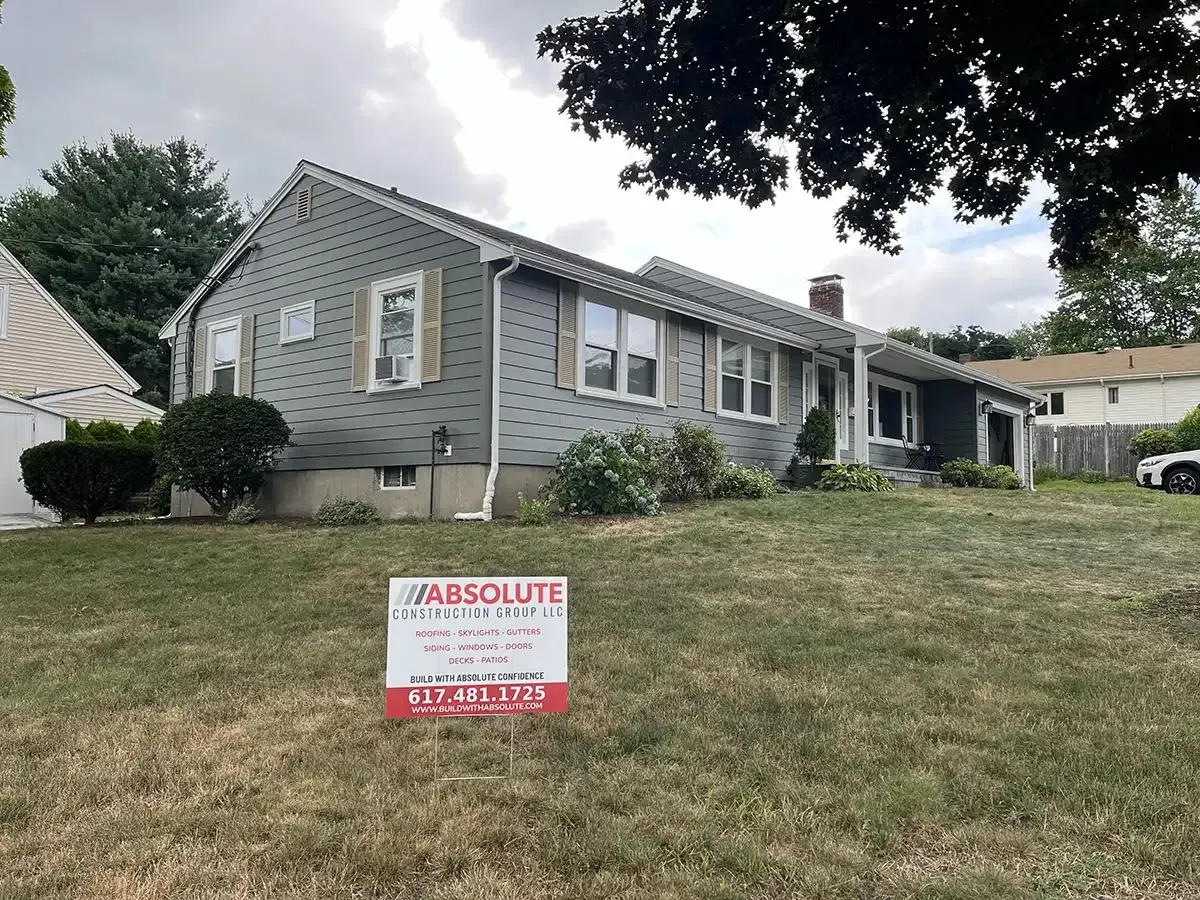 Completed siding job with the company's yard sign