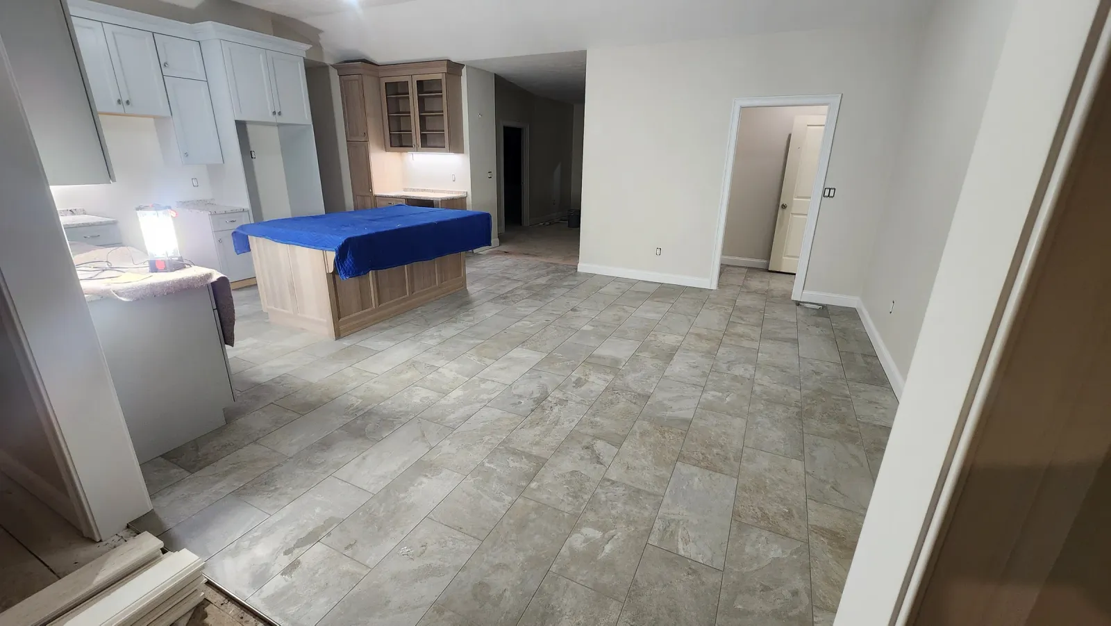 Large-format tile floor installed through an open residential interior