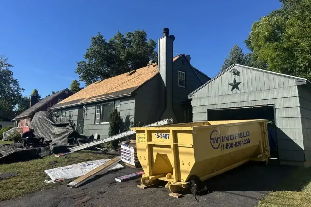 Roof tear-off exposing decking during a storm damage restoration project in Nashua NH