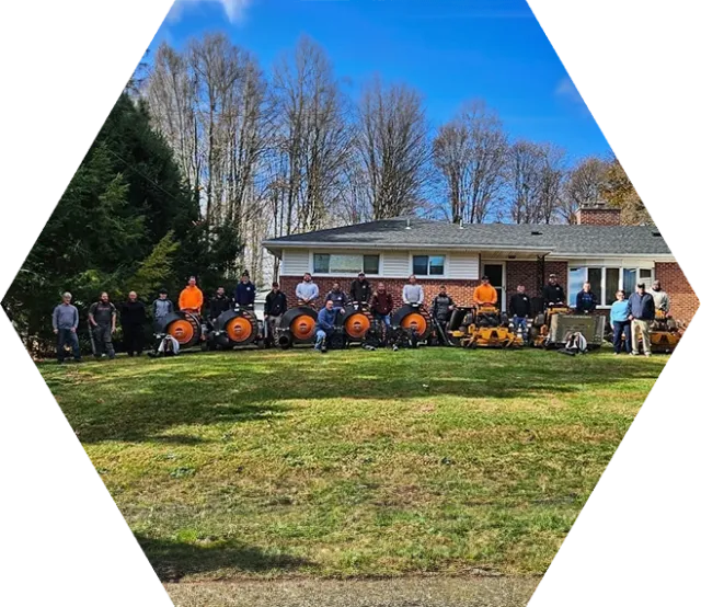 A group of people standing around in front of a house.