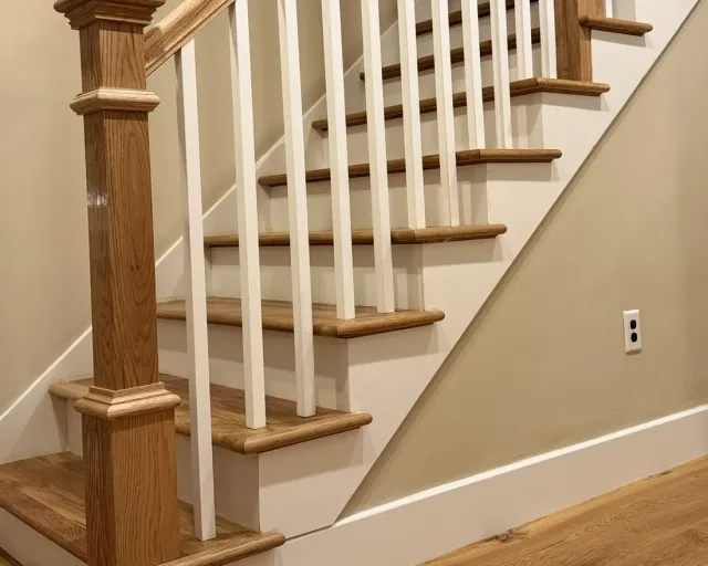 Close view of the wood and paint finish at the turn of a staircase