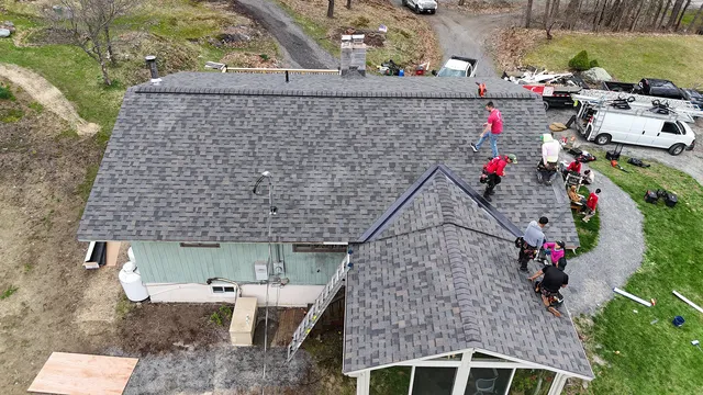 Residential roof replacement Underhill Vermont — Rivers Construction crew installing Owens Corning Duration shingles aerial view
