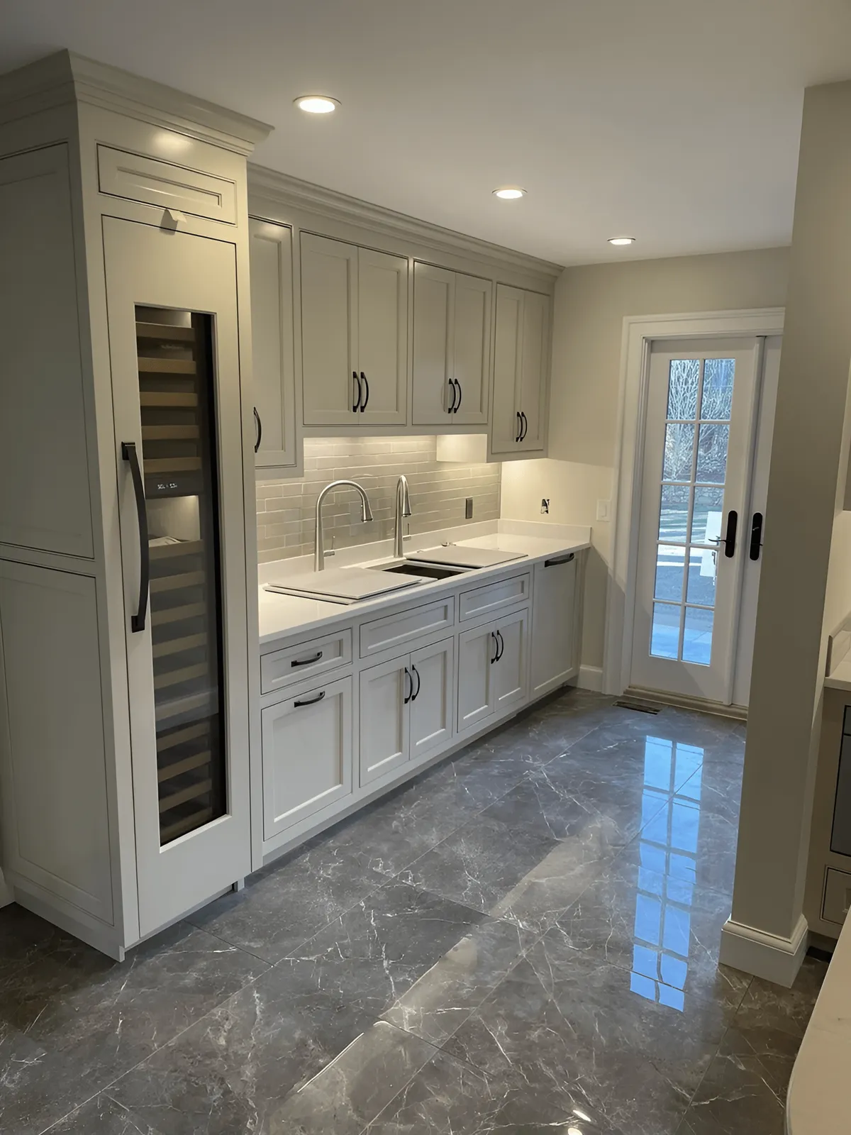 A Stylish Kitchen Showcasing Pristine White Cabinets And Luxurious Marble Countertops, Exuding A Contemporary And Clean Design.