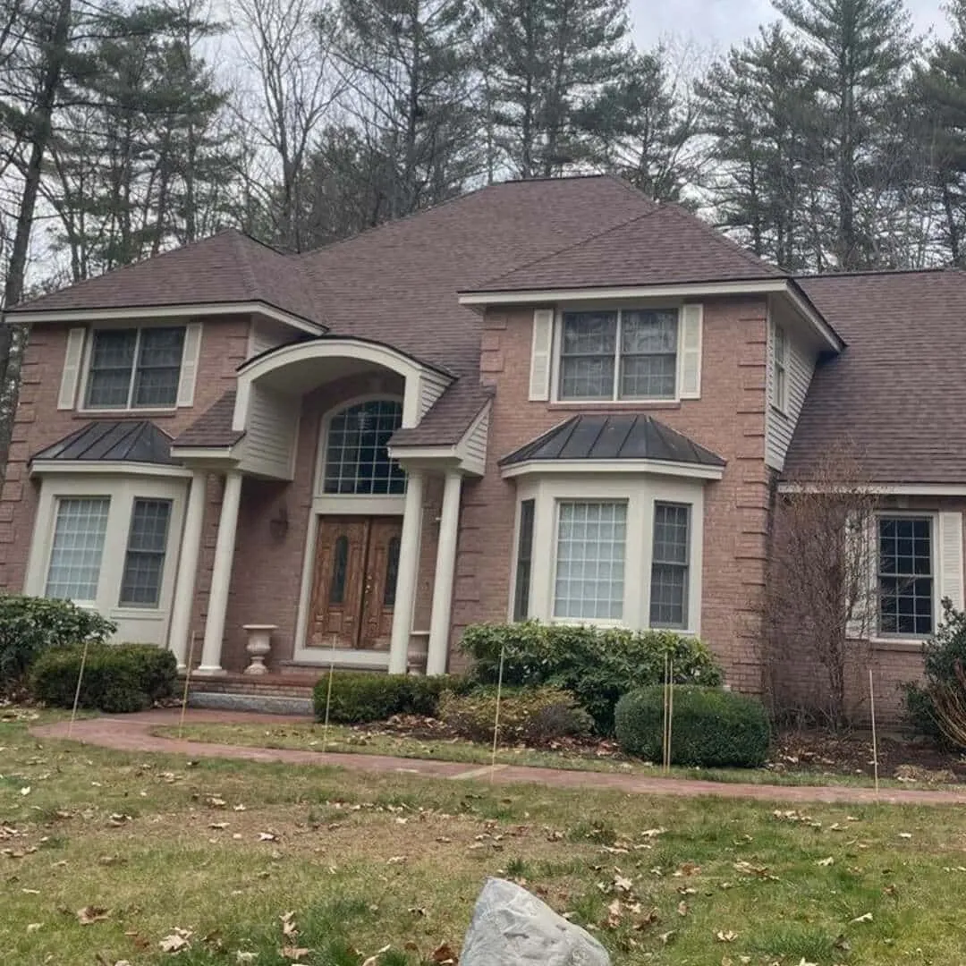 A two-story brick house with large windows