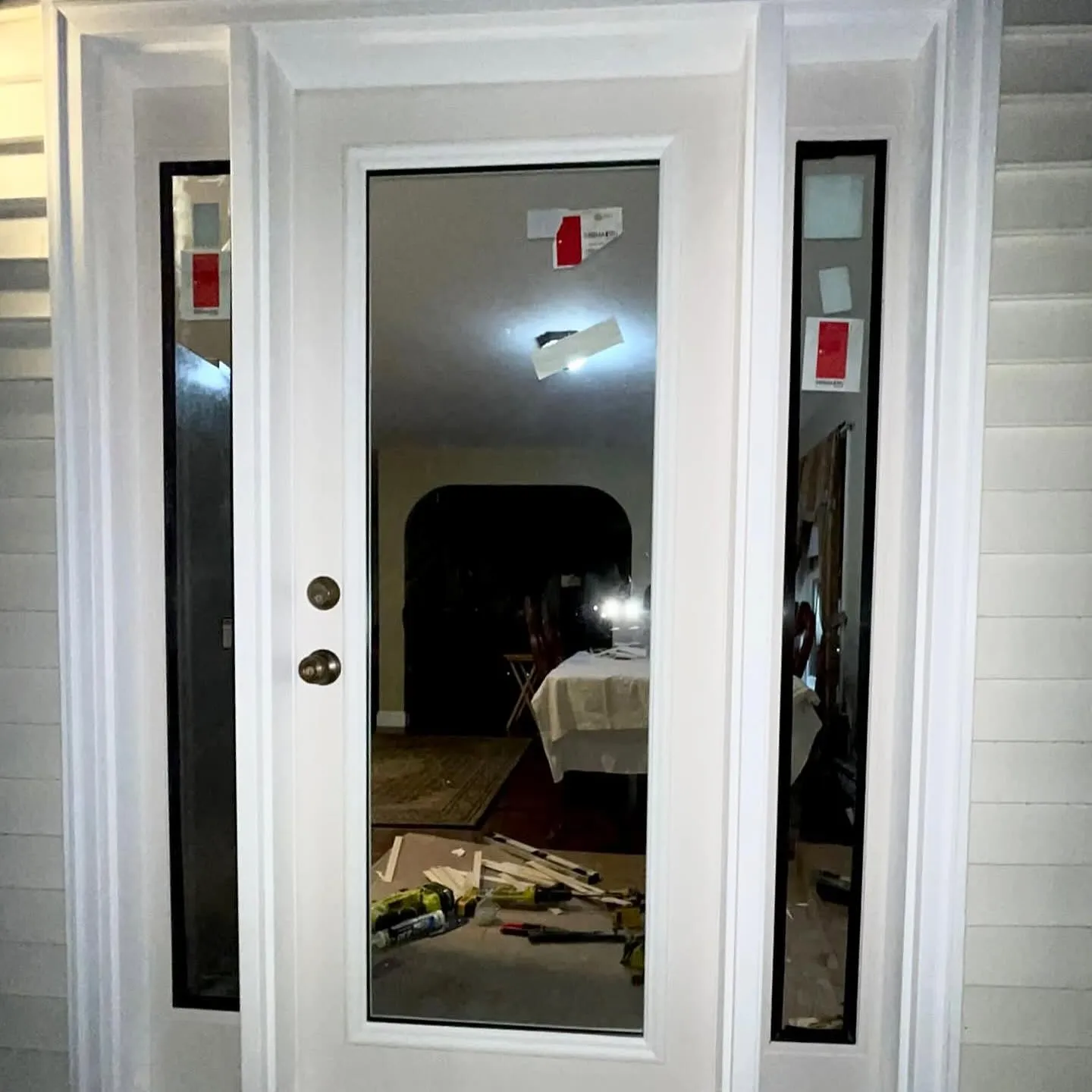 Full-glass entry door with sidelights, freshly installed