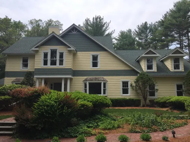 Completed roof and siding on a craftsman-style home