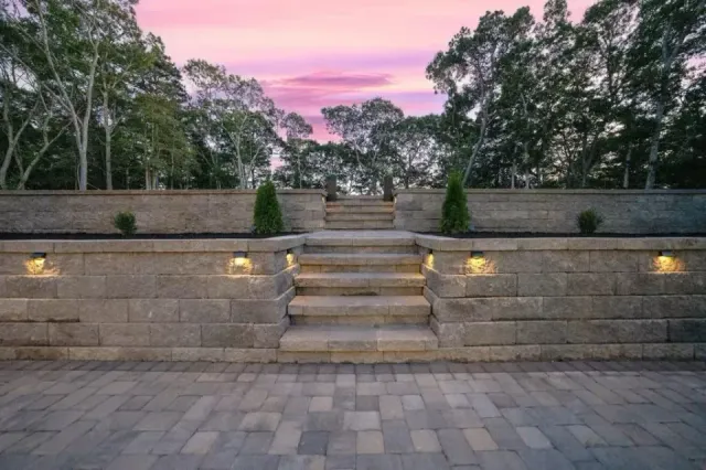 Illuminated stone steps and retaining wall at night
