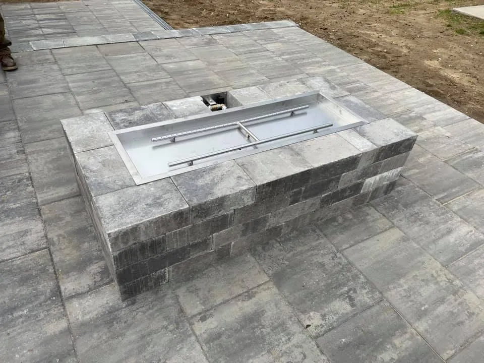 Custom garden beds with new plants and pruned shrubs