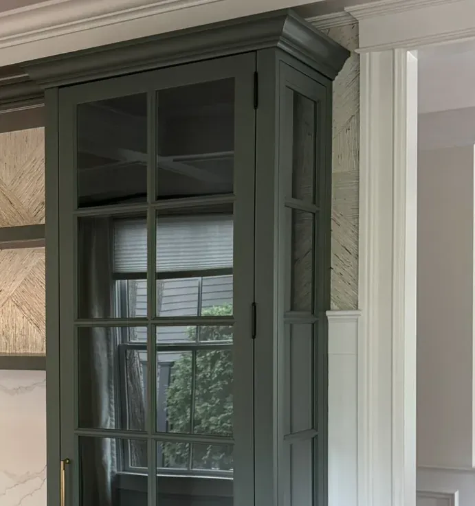 Glass cabinet door with divided panes, meeting the wall and the ceiling molding