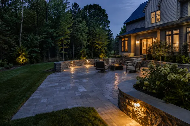 Premium illuminated paver patio and landscaped backyard