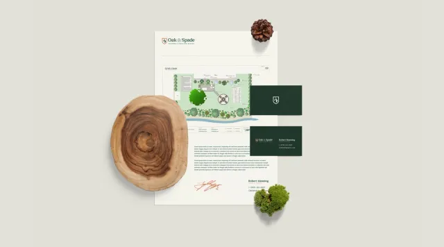 Landscape design concept with business cards, wood slice, pine cone, and moss on a light background.