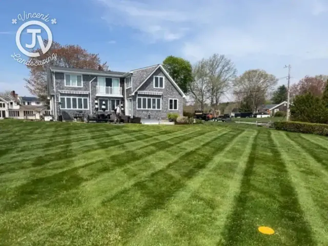 Striped lawn after weekly mowing by Vincenti Landscaping