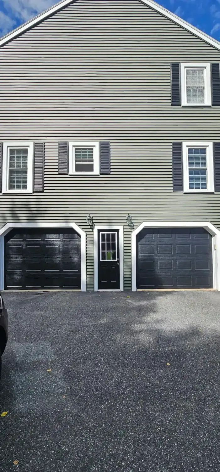 Dark carriage-style doors with iron-look hardware
