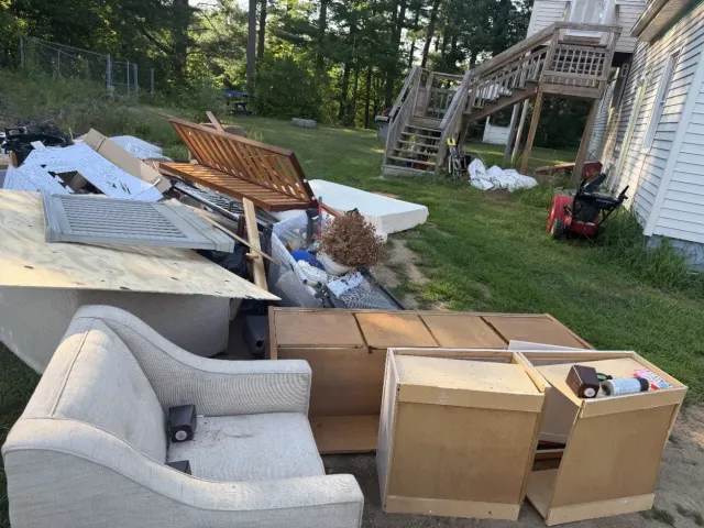 Before: furniture, cabinets and debris piled in a Somersworth backyard