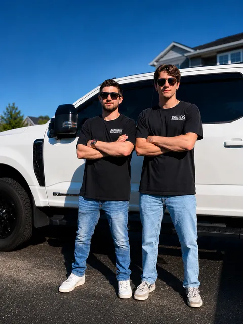 Grant & Jack McGovern standing behind the Brothers Heating and Cooling service truck