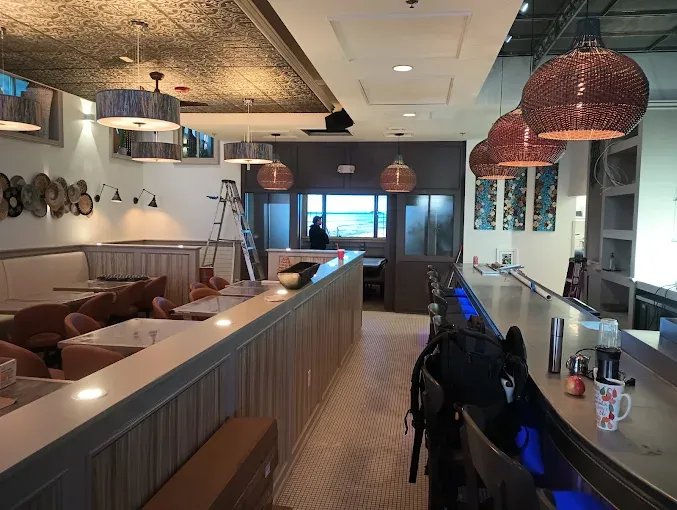 Commercial interior repaint for a restaurant and bar — detailed work around custom ceilings and fixtures. Commercial painting.