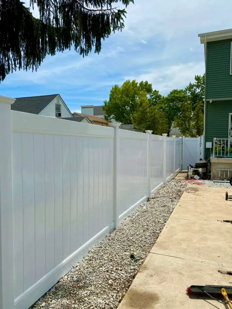 White vinyl fence with gravel