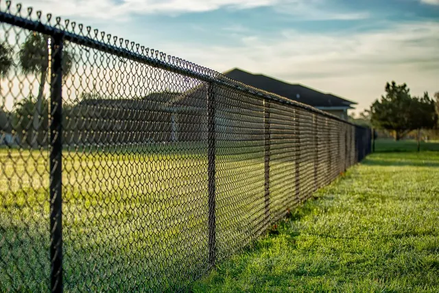 Galvanized chain link fence enclosing an open property