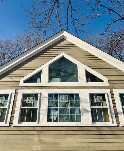 When 1882 meets 2026.

The gable wall of this addition features a pentagon window that crowns a 4' wide picture window, flanked by trapezoidal accents that mirror the roof's slope.

Blending old with new, we've matched the existing home's charm with