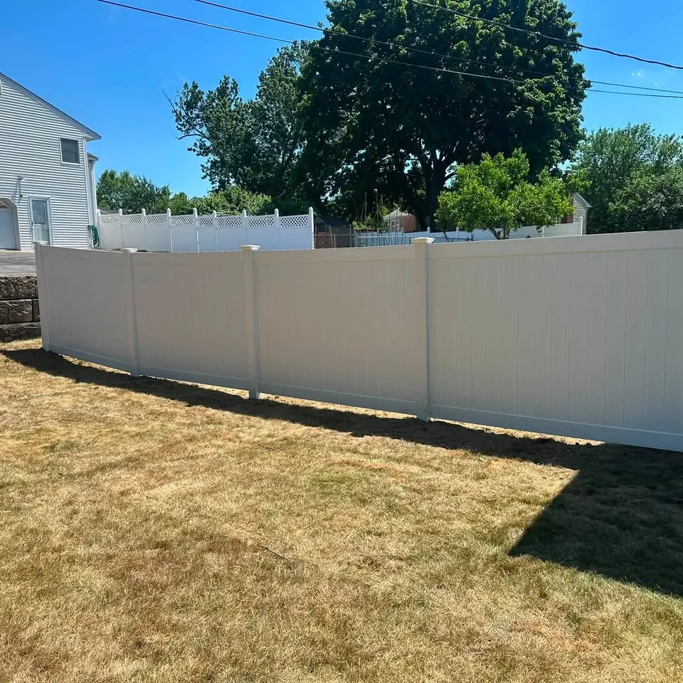 White vinyl privacy fence with lattice-top neighbouring section