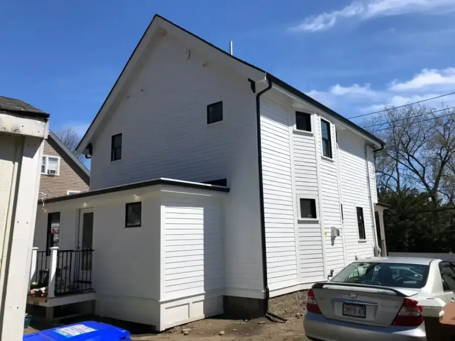 Exterior house painting in Ashland, MA showing a professional white finish