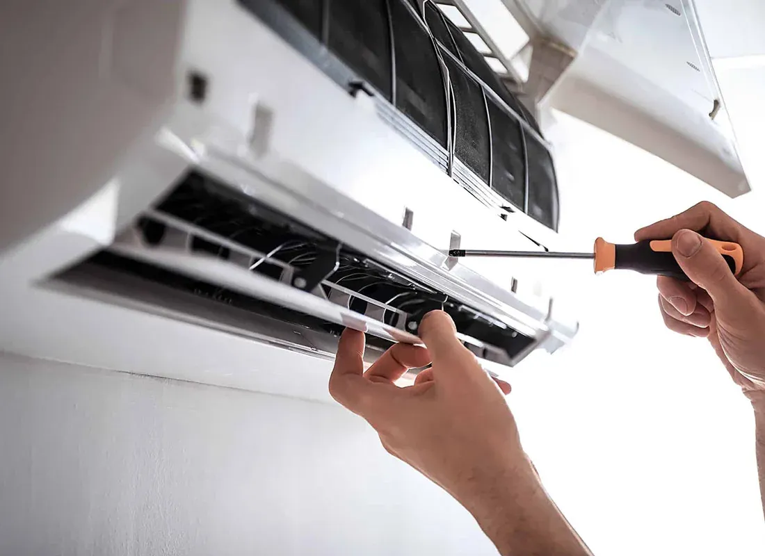 Close-up of a technician model servicing a ductless air conditioning unit