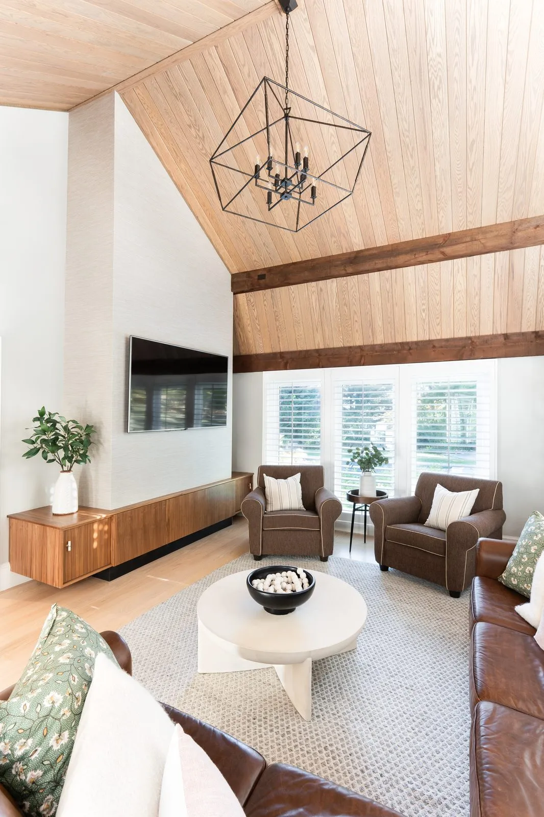 Jerusalem Road living room with vaulted white oak plank ceiling, dark wood beam, and leather seating