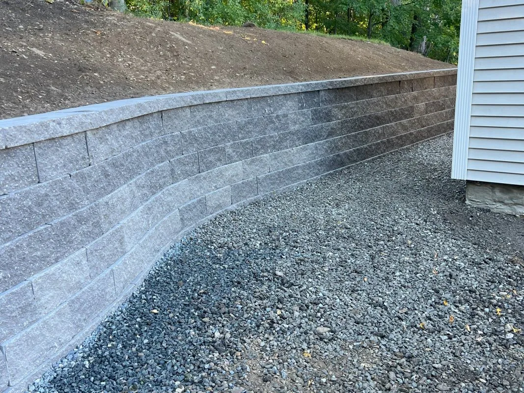 Interlocking wall installation in Andover, MA, enhancing outdoor spaces with expert craftsmanship.