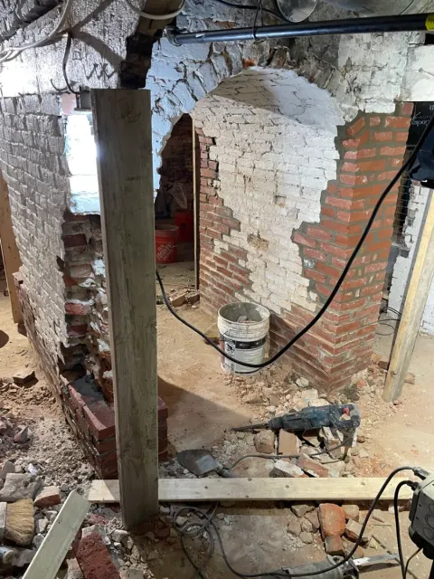 Basement masonry and foundation repairs underway inside a Boston, MA home