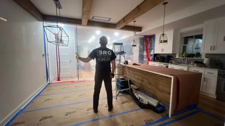 BRG technician working beside protected floors and a contained restoration work area