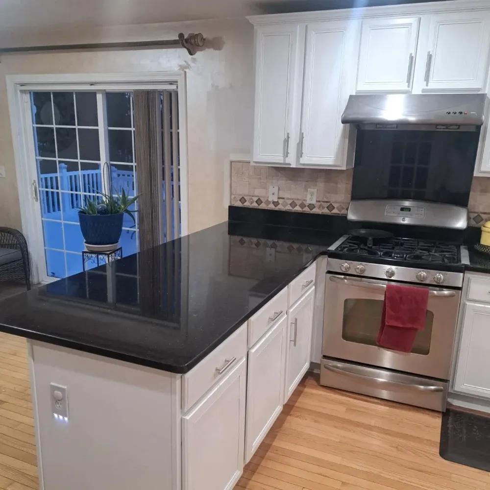 Finished kitchen remodel with painted white cabinets and black granite, Nashua NH