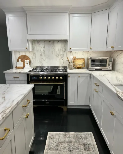 We absolutely loved this project! Our client for this is an interior designer and she went all out - an elegant black/white/gold theme on the floors and cabinets, all tied together with an absolutely stunning marble countertop and matching full slab