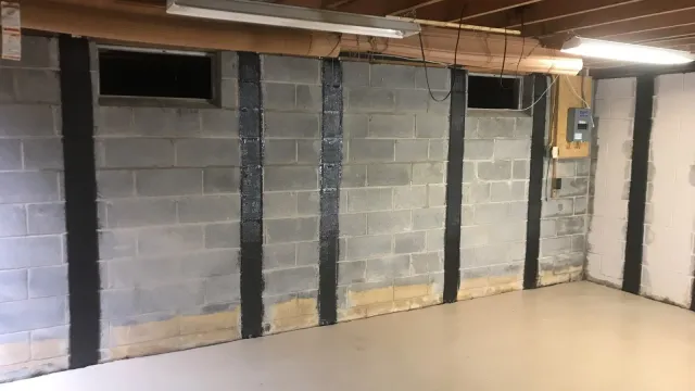 Carbon fiber strips reinforcing a bowed basement wall
