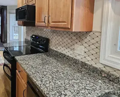 Kitchen remodel featuring tile flooring and backsplash by Grams Tile in Lunenburg, MA