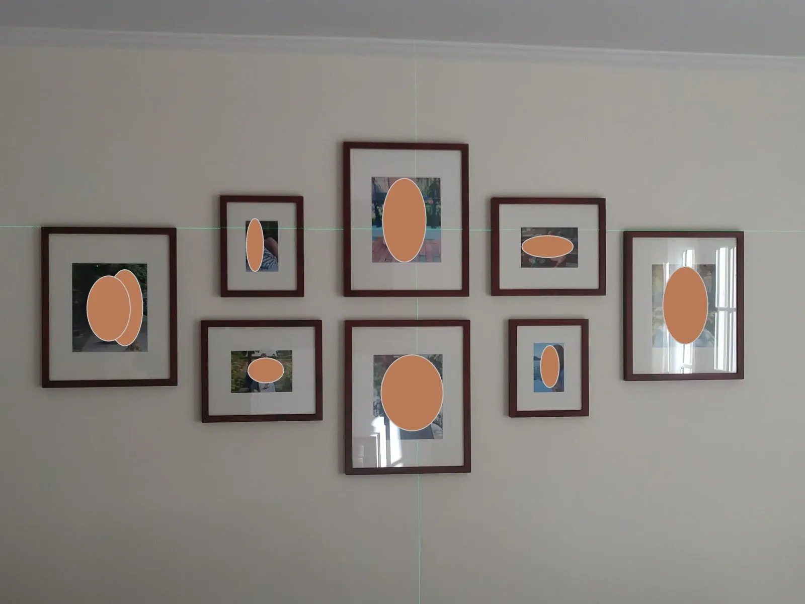 Gallery wall of framed art and mirrors hung to a layout
