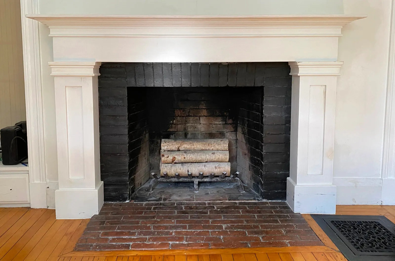 A custom fireplace mantle designed to complement the original molding and style of the client's historic home