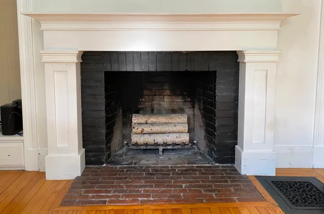 A custom fireplace mantle designed to complement the original molding and style of the client's historic home
