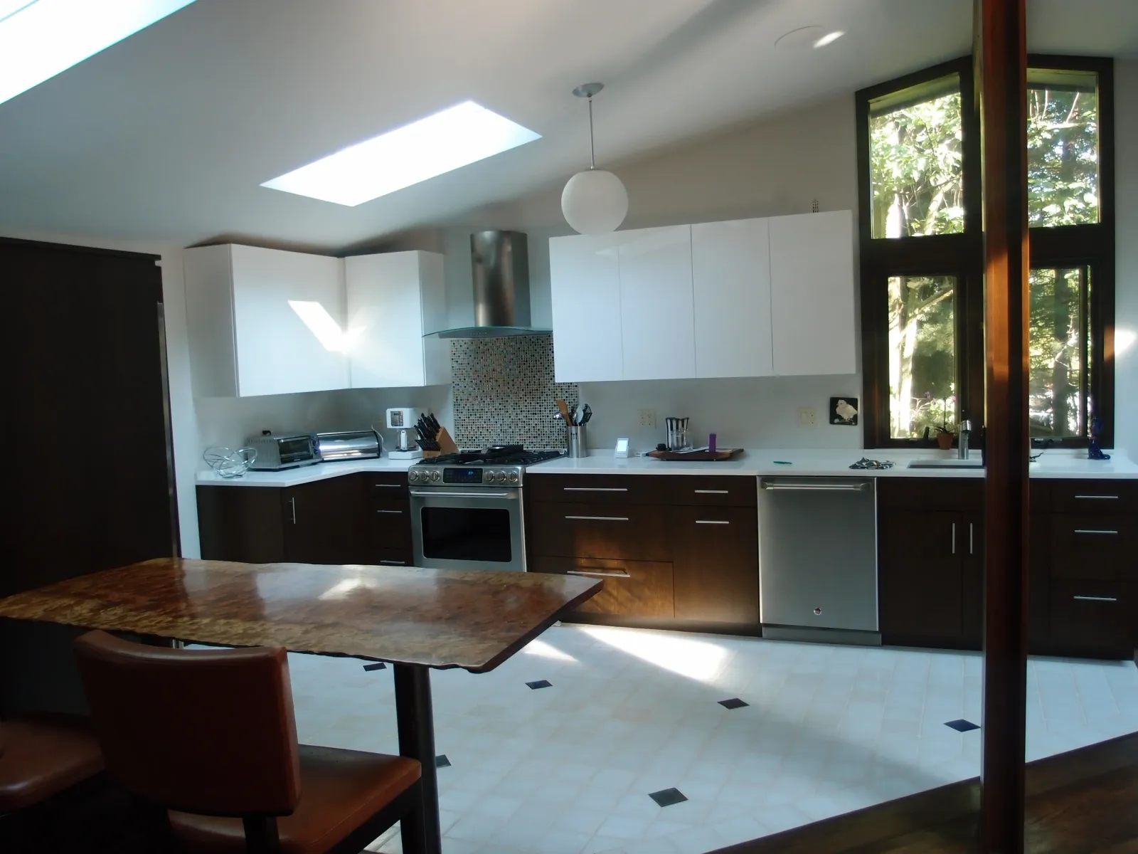 Modern kitchen under a vaulted ceiling with skylights