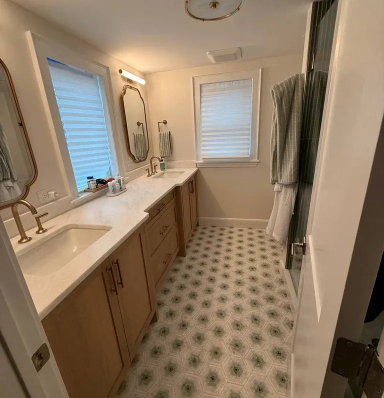 Clean bathroom after house cleaning service, with polished sink, disinfected toilet, and fresh, organized space.