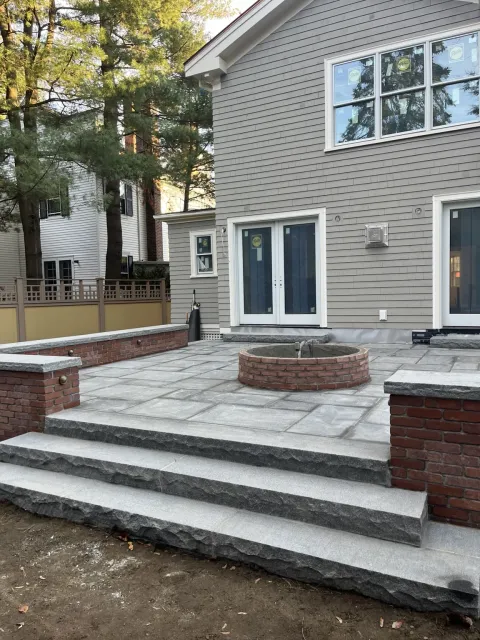 finished bluestone patio and brick wall masonry project