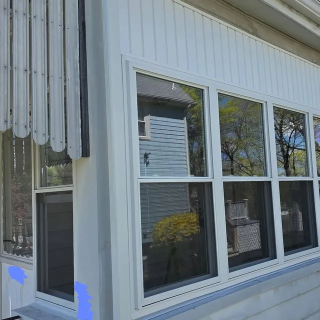 New siding and window trim on a porch elevation