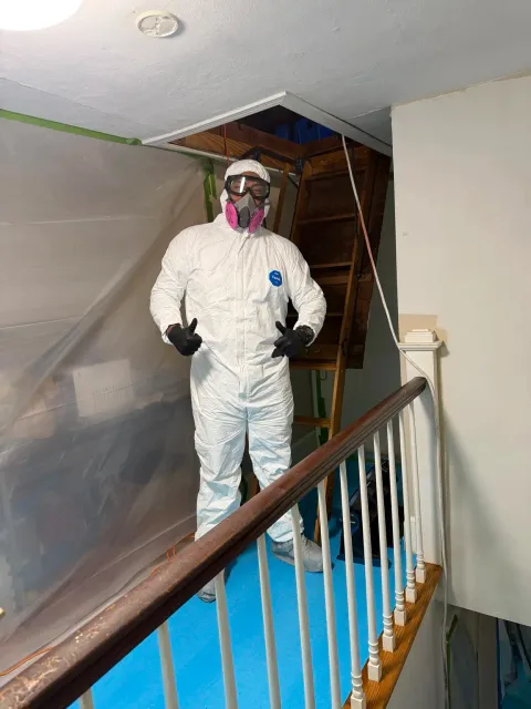 IRP mold remediation technician in PPE at a controlled attic access in Smithfield Rhode Island