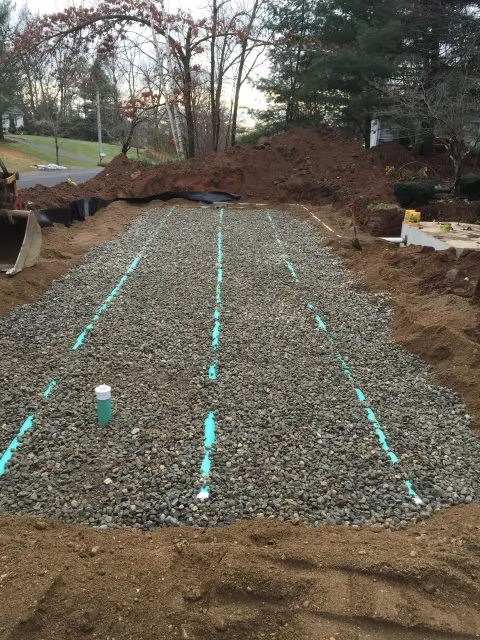 A large pile of gravel with pipes going through it.
