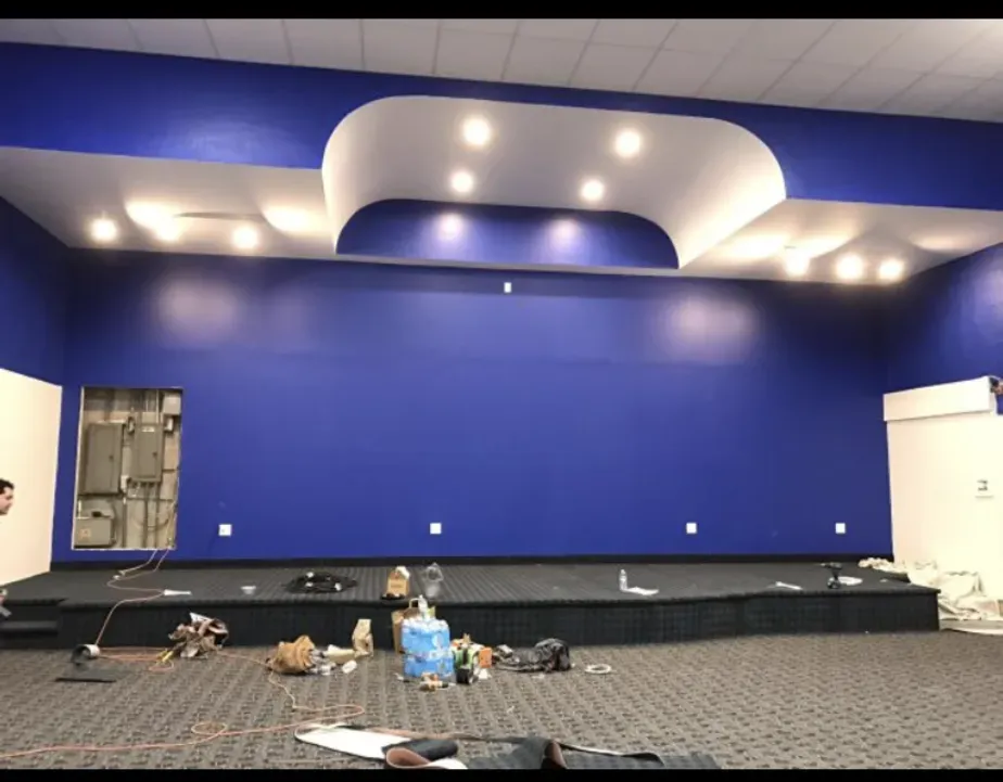 An empty room with blue walls and a stage